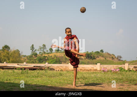 Junger Mann einen geflochtenen Ball in einem kleinen Dorf in der Nähe von Inle-See, Myanmar. Stockfoto