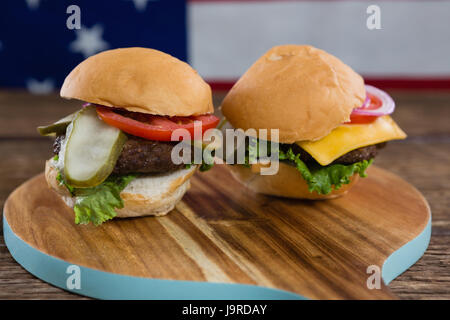 Nahaufnahme der Burger auf Holztisch mit 4. Juli Thema Stockfoto