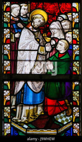 Glasmalerei-Fenster Darstellung einen Priester geben Heilige Kommunion in der Kathedrale St. Bavo in Gent, Flandern, Belgien. Stockfoto