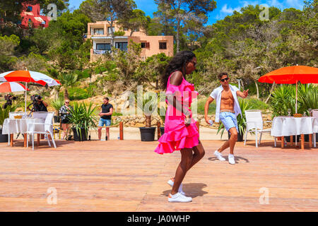 Insel IBIZA, Spanien - 17. Mai 2017: paar junge Leute tanzen auf Terrasse des Restaurant am Strand in Cala Carbo, während sie in der Reihenfolge t gefilmt werden Stockfoto