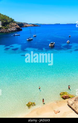 Nicht identifizierte zwei junge Paare am Strand in Cala Salada Bucht berühmt für seine Azure kristallklares Meerwasser, Insel Ibiza, Spanien Stockfoto