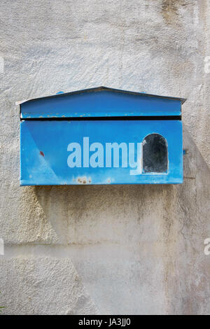 blauen Briefkasten vor der alte Betonmauer von zu Hause Stockfoto