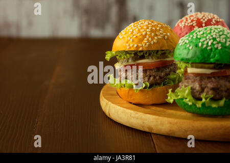 Multi farbige Burger auf Holzplatte selektiven Fokus Stockfoto