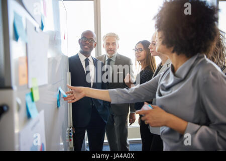 Gruppe von gemischten Geschäftsleute mit einem Treffen mit einer weißen Tafel in hellen Büroflächen Stockfoto