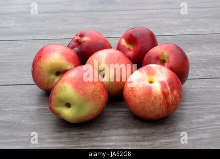 Frische Nektarinen auf Holztisch. Stockfoto