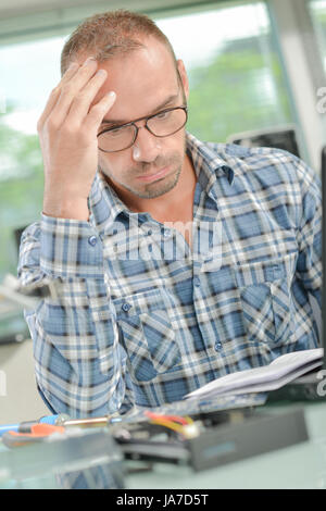 Bauarbeiter, ein Handbuch zu lesen Stockfoto