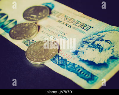 Jahrgang suchen 100 Mark-Banknote aus der DDR (Ostdeutschland) mit Karl Marx mit 1 Mark Münze - Hinweis: seit der deutschen Wiedervereinigung im Jahr 1989 nicht mehr in Gebrauch Stockfoto