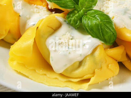 Spinat und Ricotta gefüllte Pasta serviert mit weißen Sahne-Sauce und geriebenem Parmigiano Stockfoto