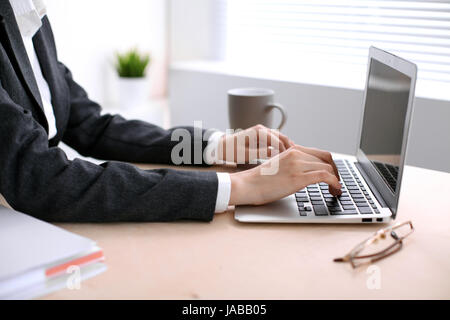 Nahaufnahme des Business Frau Hände Tippen auf Laptop-Computer im weißen farbigen Büro. Stockfoto