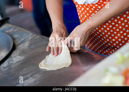 Thai Roti Pfannkuchen vorbereiten. Traditionelle Art der Zubereitung südostasiatischer Crepes. Stockfoto