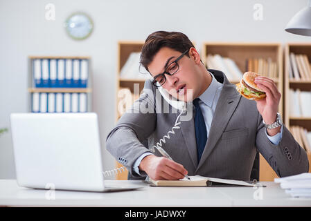 Hungrige lustige Geschäftsmann Essen Junk-Food-sandwich Stockfoto