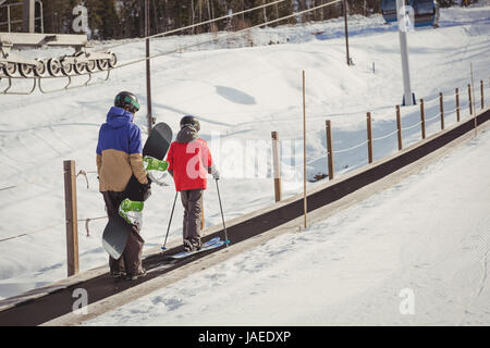 Mutter und Sohn, Skifahren im Winter auf Förderband Stockfoto