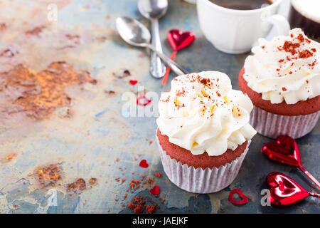 Leckeren roten samt Cupcakes zum Valentinstag auf rostigen alten Metall-Hintergrund. Urlaub-Food-Konzept. Kopieren Sie Raum. Stockfoto