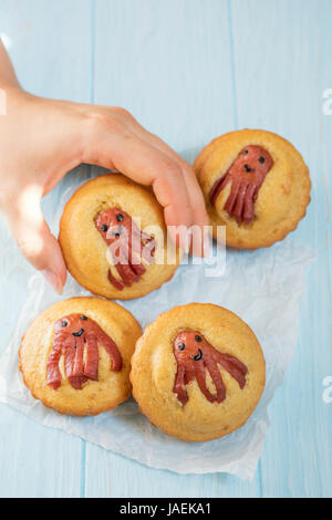 Kind lustig Essen. Maisbrot-Muffins mit Wurst Krake Stockfoto