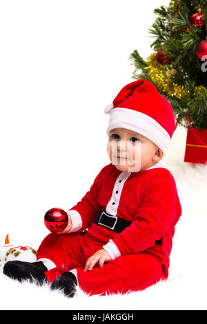 Baby mit einem roten und weißen Weihnachten Santa Hut und Anzug, isoliert auf einem weißen Hintergrund. Stockfoto