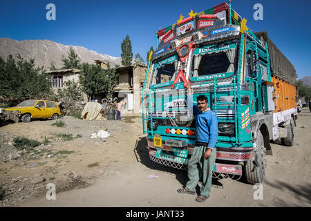 Indische LKW-Fahrer stehend neben seinem gut geliebt und bunte indische LKW im extremen Gelände des indischen Himalaya. Höchsten Straßen der Welt Stockfoto