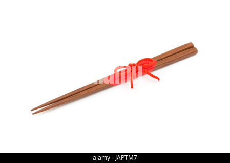 Japanische Essstäbchen aus Holz verpackt in rotem Papier und roten Seil auf weißem Hintergrund. Stockfoto