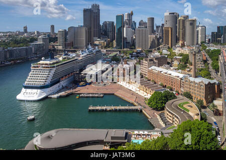 Ein Kreuzfahrtschiff im Hafen von Sydney mit der Stadt im Hintergrund Stockfoto