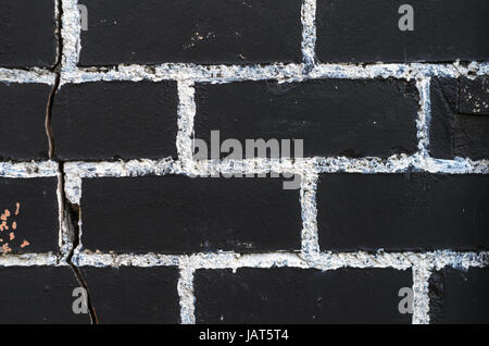 Groben Ziegel Wand Textur in schwarz mit Malerei Nähte in weiß lackiert. Mauerwerk-Textur Stockfoto