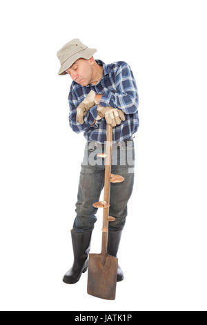 Arbeitslosen in Handschuhen hält den Spaten Stockfoto