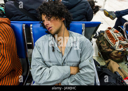 Menschen schlafen und warten darauf, Board-Flugzeuge auf dem Flughafen. Stockfoto