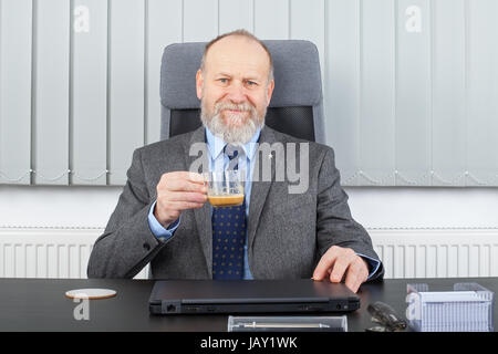 Bild von einem nachdenklichen Manager in einer Kaffeepause im Büro Stockfoto
