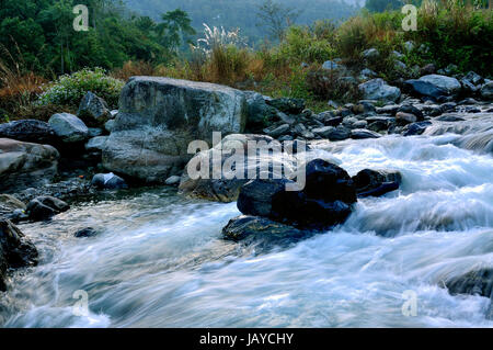 Reshi Fluss Wasser fließt auf Felsen am Morgengrauen, Sikkim, Indien Stockfoto