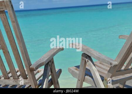 Zwei Stühle Betten im Wald am tropischen Strand mit blaue Meer im Hintergrund Stockfoto