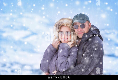 Closeup Portrait schöne Paar unter Schneefall in den Bergen, romantischen Winter Urlaub, Kälte, Liebe Konzept stehen Stockfoto