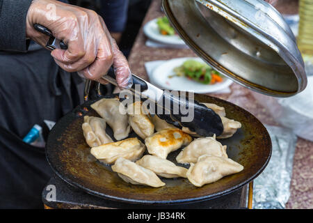 Knödel auf Grill braten Pfanne auf Garküche urbane Food Festival. Stockfoto