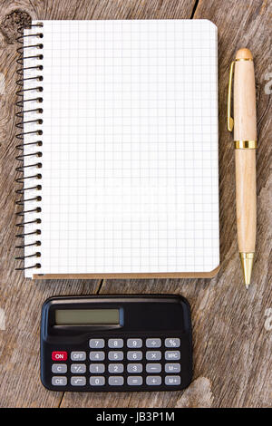 Addiert man Figuren Konzept mit Taschenrechner, Stift und Notizbuch auf dem hölzernen Hintergrund Stockfoto