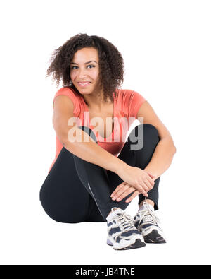 Freigestelltes Foto Einer Jungen Sportlerin, sterben Auf Dem Boden sitzt Stockfoto