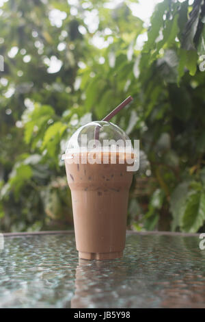 Kunststoff-Glas Eis Kaffee Mokka auf dem Glastisch im Café im freien Stockfoto