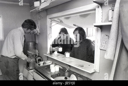 1973, historisches Bild von zwei Kunden, die draußen unter dem Baldachin am Schalter des berühmten Blackheath Tea Hut mit ihren Tassen Tee stehen, während der männliche Kellner den Teekocher aus einer metallenen Wasserkanne füllt. Die einfache Snackbar war ein bekannter Raststopp für Leute, die auf der A2 Straße in Greenwich, South London, SE3 unterwegs waren. Stockfoto