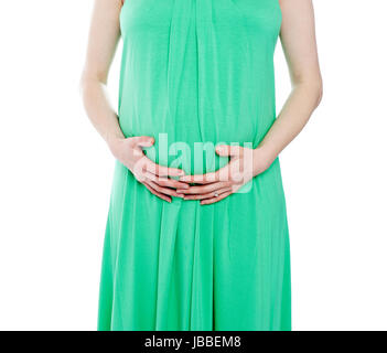 Bild der schwangeren Frau in grünem Kleid beschnitten Stockfoto