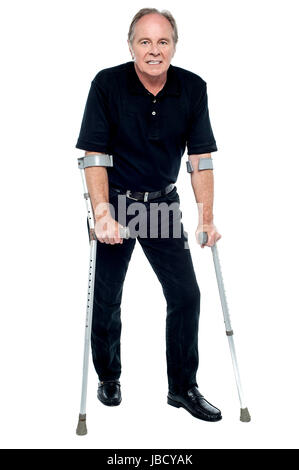 Senioren, seine ersten Schritte nach der erfolgreichen Operation. In die Kamera schaut. Stockfoto