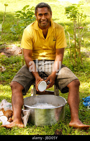 Lokale Mann Schaben Kokosnüsse in Lavena Dorf, Insel Taveuni, Fidschi. Taveuni ist die drittgrößte Insel in Fidschi. Stockfoto