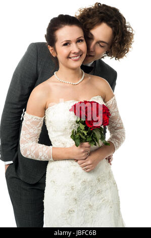 Mann, Flüstern in den Ohren einer Braut Stockfoto