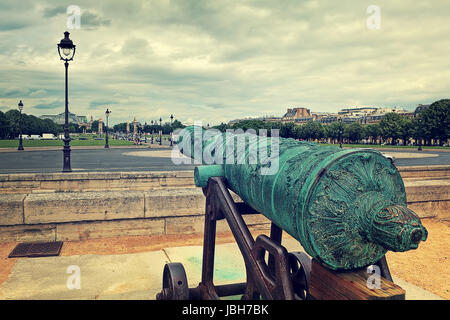 Mittelalterlichen Kanone auf Les Invalides mit Blick auf die Stadt unter bewölktem Himmel in Paris, Frankreich. Stockfoto