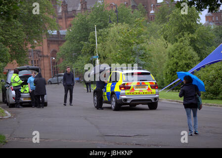 Glasgow, Schottland. 11. Juni. Die beiden Elemente der in diesem Jahre britische Sommer waren anwesend, als Regen auf die West End Festival Big Sunday im Kelvingrove Park strömte. Besucher wurden stark durch die Polizei und private Sicherheitsdienste überwacht. Bewaffnete Polizei patrouilliert Parks im Fahrzeuginneren während Taschen durch private Sicherheitspersonal an den Eingängen durchsucht wurden.  Polizisten patrouillierten Veranstaltungsort zu Fuß oder Fahrrad.  Kredit Gerard Fähre/Alamy Live-Nachrichten Stockfoto