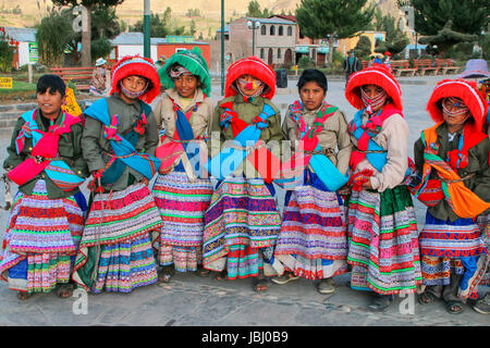 Jungs in traditionellen Kostümen stehen auf dem Hauptplatz in Yanque Stadt im Colca Canyon, Peru. Yanque gehört zu den drei wichtigsten touristischen Städten des Co Stockfoto