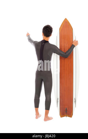 Surfer-Mann, ein Surfbrett und Punkt irgendwo Stockfoto