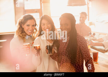 Porträt Lächeln Frauen Freunde trinken Bier in der Bar Stockfoto