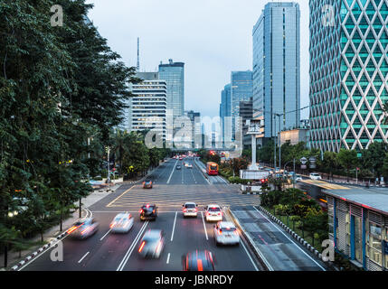 Verkehr, mit Bewegungsunschärfe, Eile entlang der Thamrin-Allee im Herzen der Innenstadt von Jakarta in Indonesien Hauptstadt in der Nacht gefangen. Stockfoto