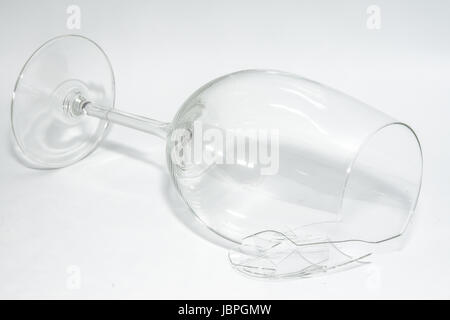 Zerbrochene zerbrochene Weinglas mit scharfen Splitter liegen auf weißem Hintergrund Stockfoto