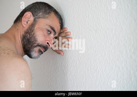 Deprimiert mittleren Eatsern Mann an die Wand gelehnt Stockfoto