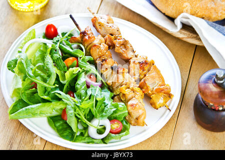 Gegrillter Hühnerspieß mit Rucola-Salat mit Brot Stockfoto