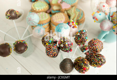 Hintergrund der dekorierten Süßigkeiten und Kuchen Pops auf Holzbrettern Stockfoto