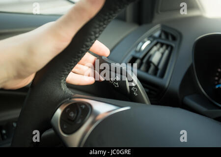 Nahaufnahme Foto Frau Auto fahren und mit Blinker Schalter Stockfoto