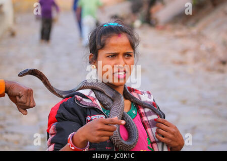 Einheimische Frau Holding indische Cobra in der Straße von Jaipur, Indien. Jaipur ist die Hauptstadt und größte Stadt im indischen Bundesstaat Rajasthan. Stockfoto